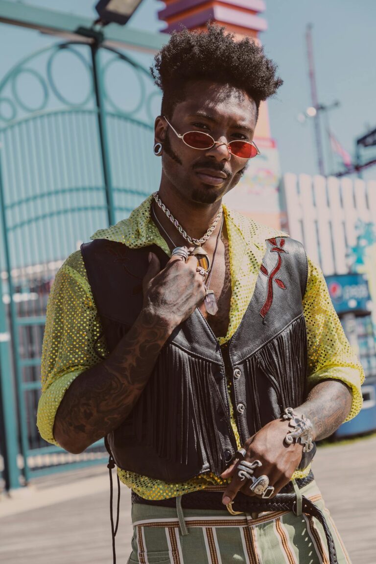 Man Wearing Yellow Shirt and Brown Leather Vest With Fringe